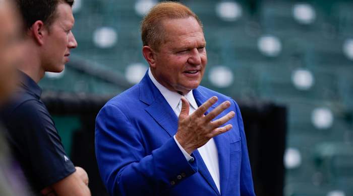 Scott Boras gestures with his hand while stands on the field before the game